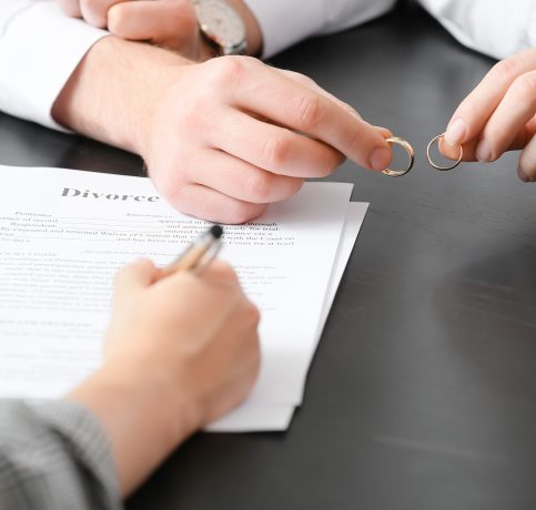 Couple taking off wedding rings in lawyer's office